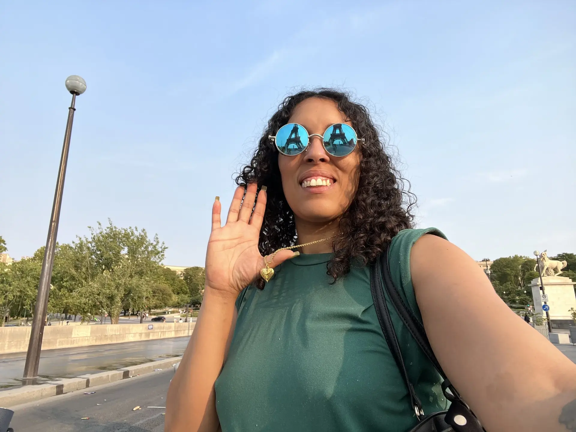 Yhicey Hawt wearing green and mirrored sunglasses outdoors